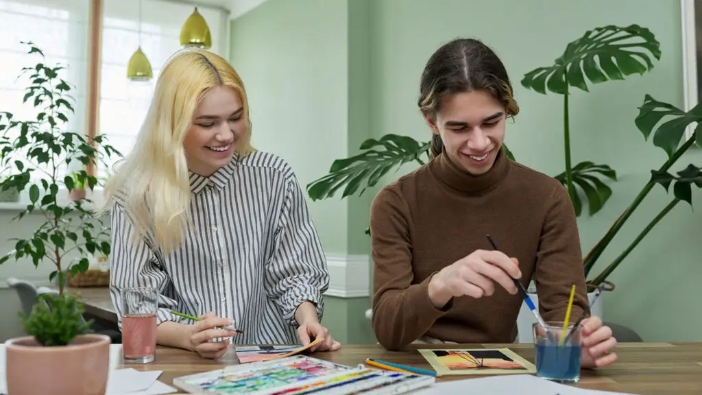Two people painting and creating art, illustrating design and branding concepts.